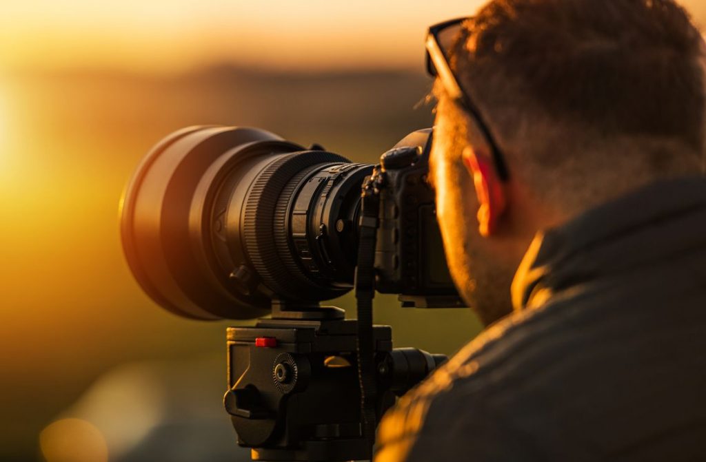 a professional photographer taking sunset photographs